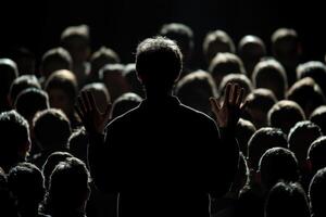 Crowd engages with speaker during a passionate presentation in a dimly lit auditorium photo