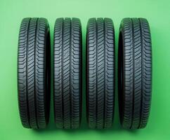 High-quality car tires displayed on a vibrant green background for automotive enthusiasts and consumers seeking reliable options photo