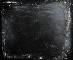 Old blackboard with chalk marks and scratches, perfect for creative presentations or artistic displays in a classroom setting photo