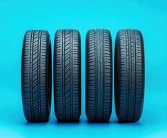 High-quality automotive tires displayed in a row against a bright blue background showcasing modern design and texture photo