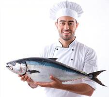 Chef holds fresh tuna fish proudly, showcasing culinary skills in a professional kitchen setting photo