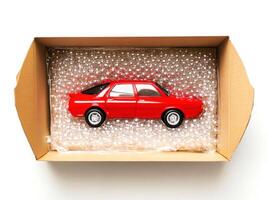 Model car carefully packed in cardboard box with bubble wrap for safe delivery photo