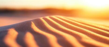 close up view of textured sand dunes illuminated by warm sunlight, showcasing intricate patterns and soft curves of sand. serene atmosphere evokes sense of tranquility and natural beauty photo
