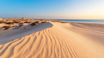 Wind blown sand creates soft flowing lines on serene beach landscape, showcasing beauty of nature patterns and tranquil meeting of land and sea photo