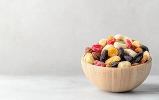 Mixed tropical dried fruits and nuts in large wooden bowl, showcasing vibrant colors and textures, perfect for healthy snacking or decoration photo