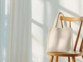 simple tote bag rests elegantly on wooden chair, showcasing its minimalist design against softly lit background. gentle shadows create serene atmosphere photo
