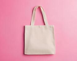 simple and clean image of tote bag lying flat on pink background, showcasing its versatile design and neutral color, perfect for everyday use photo