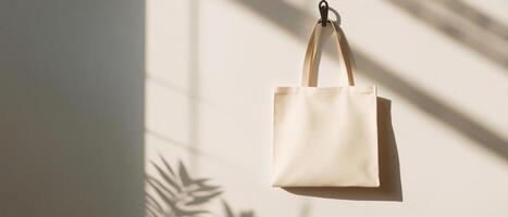 minimalist reusable tote bag hanging from hook, showcasing natural fabric texture and soft shadows, creating serene and eco conscious atmosphere. Perfect for advertising with ample copy space photo