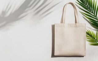 high angle view of reusable tote bag on light background, surrounded by green palm leaves, evokes sense of eco friendliness and style photo