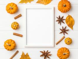 Blank white frame mockup surrounded by autumn leaves, pumpkins, and spices creates warm, inviting atmosphere perfect for seasonal decor photo