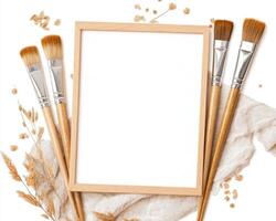 wooden frame surrounded by paintbrushes and dried flowers, perfect for showcasing art. composition evokes creativity and inspiration in modern art studio photo