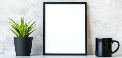 blank frame mockup on neutral toned office wall with plant and cup, creating minimalist and modern workspace atmosphere photo