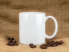 blank white mug sits on burlap background surrounded by coffee beans, perfect for showcasing your favorite beverage or design photo