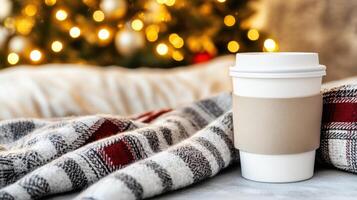 Cozy coffee cup on blanket with festive Christmas tree background, creating warm holiday atmosphere. Perfect for winter season vibes photo