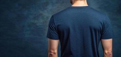 Navy t shirt displayed from back view against textured background, showcasing clean and simple design. Ideal for casual wear or promotional use photo