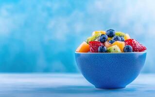 Fresh fruit bowl with blueberries, strawberries, kiwi, and pineapple, set against soft blue background, evokes sense of health and vitality. Perfect for nutritious snack or dessert photo