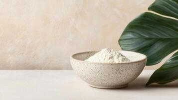 Organic stevia powder in ceramic bowl with green leaf nearby, creating natural and fresh atmosphere. Perfect for healthy cooking and baking photo