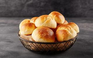 Freshly baked artisan bread rolls in wire basket, golden and warm, perfect for any meal. Their soft texture and inviting aroma make them delightful addition to table photo