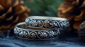 Pair of 'Sami' inspired silver bracelets featuring traditional designs symbols worn by women in Scandinavia representing their connection to nature and the reindeer photo