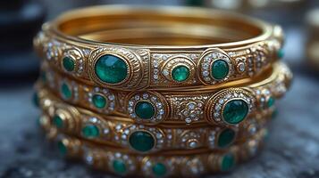 Delicate set of traditional 'Kada' bangles crafted gold and embellished with emeralds worn by Sikh women in Punjab India symbolizing strength and beauty photo