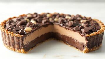 A delectable chocolate tart features creamy layers and a nutty crust, enticing all who see it photo