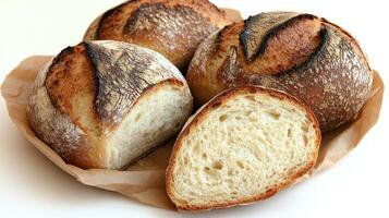 Artisan bread rolls on parchment, crusty outside with a fluffy interior photo