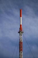 Top of red and white radio tower photo