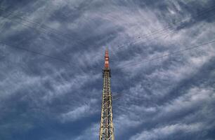 Red and white radio tower in an unusual angle. photo
