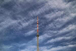Red and white radio tower in unusual angle. photo