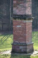 Freestone obelisk in the former palace garden of long abandoned hunting lodge Sommerschloss Blumenstein - summer palace Blumenstein in Wildeck, Hesse, Germany photo