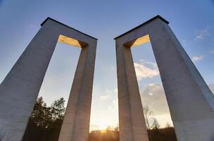 Symmetrical wide angle view of two concrete arches in front of the sun. The image was created using a HDR technique. photo