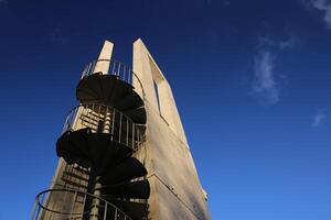 Lookout tower with spiral staircase seen from below. The sky is darkened due to the use of a polarization filter photo