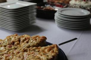 Rhubarb cake with plates in the background. photo