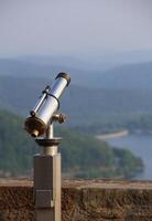 View over the mountains in Hesse, Germany, besides an old-fashioned telescope. photo