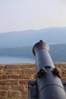 View over the mountains in Hesse, Germany, besides an old-fashioned cannon. photo