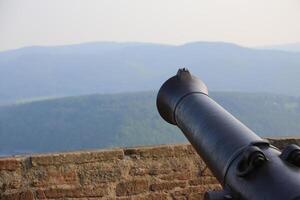 View over the mountains in Hesse, Germany, besides an old-fashioned cannon photo