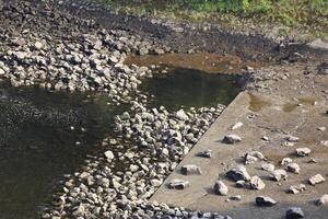 Stones and concrete on the edge of a river in Germany. photo