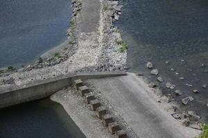 Rock dams with road and water on all sides. photo