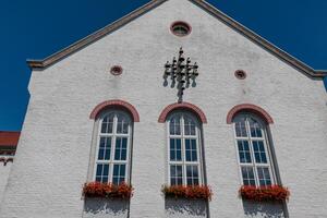 A white building with a clock on the front photo