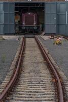 A train on a track with a building in the background photo