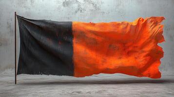 A textured flag with bold orange and black colors flows softly, capturing the essence of movement photo
