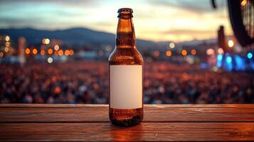 A cold, amber bottle rests on a wooden surface, with a lively crowd enjoying a sunset backdrop photo