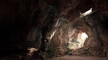 A mysterious tunnel with rays of light piercing through the darkness video