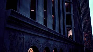 Historic building at dusk with illuminated arches and modern architecture video