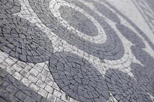 Cobblestone mosaic creating circular patterns on prague pavement photo