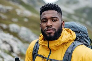 Hiker in Vibrant Yellow Jacket Exploring Scenic Mountain Landscape photo