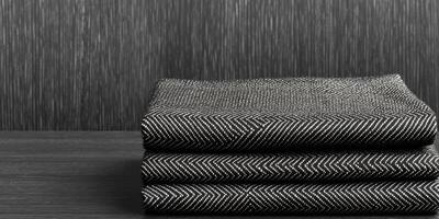 Folded Black and White Textured Fabrics on Dark Background photo