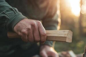 Craftsman skillfully shaping wood during golden hour in a serene forest setting, showcasing dedication to traditional woodworking photo