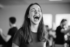 Happy young woman laughing in a lively indoor setting filled with people engaged in conversation and activities photo