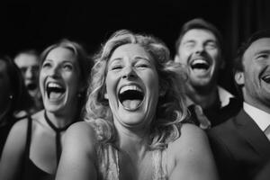 Lively audience enjoying a comedy show at an evening event with laughter and smiles photo